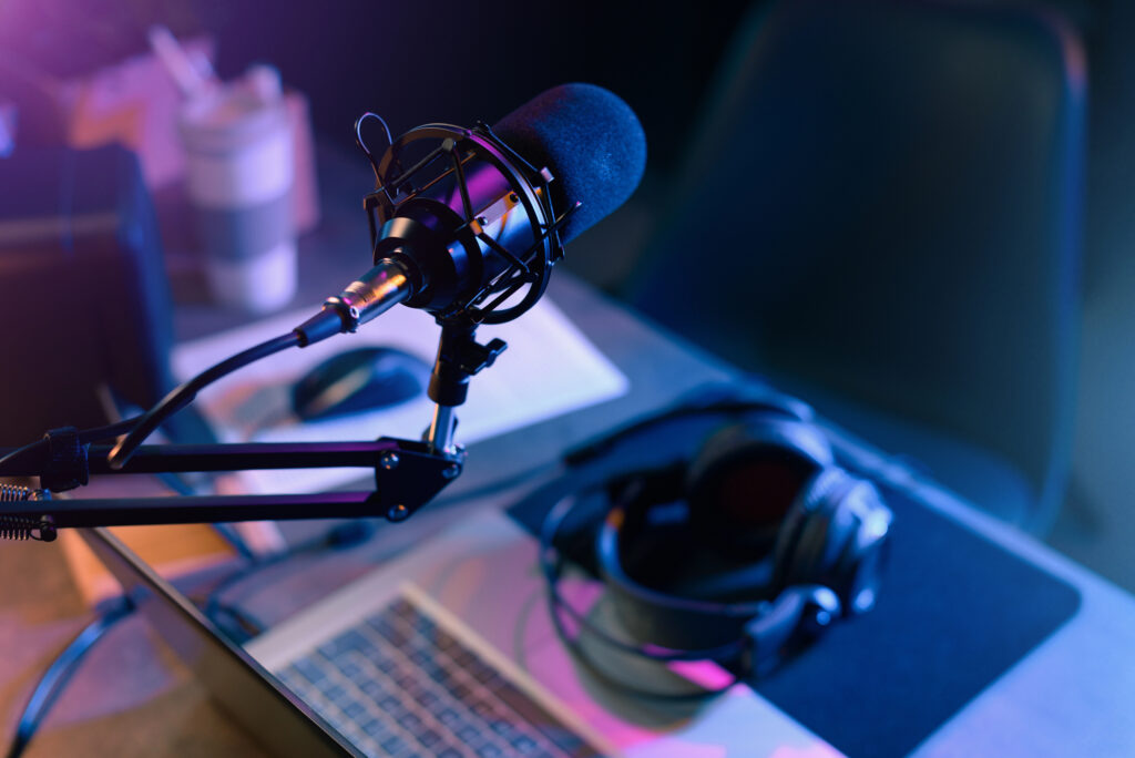 A microphone and headphones during a podcast recording session that will be professionally transcribed